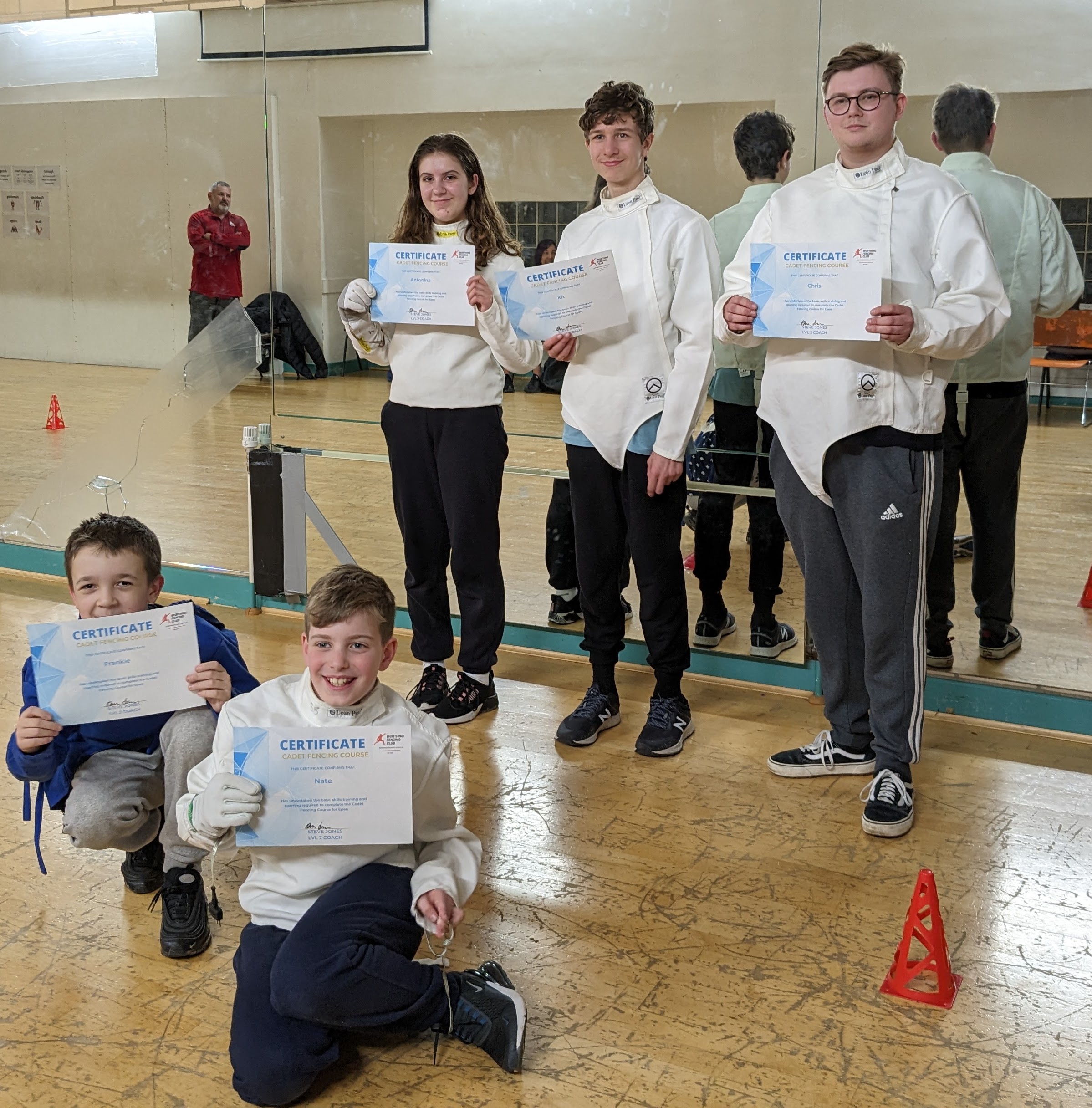 Fencers receiving their beginner course certificates
