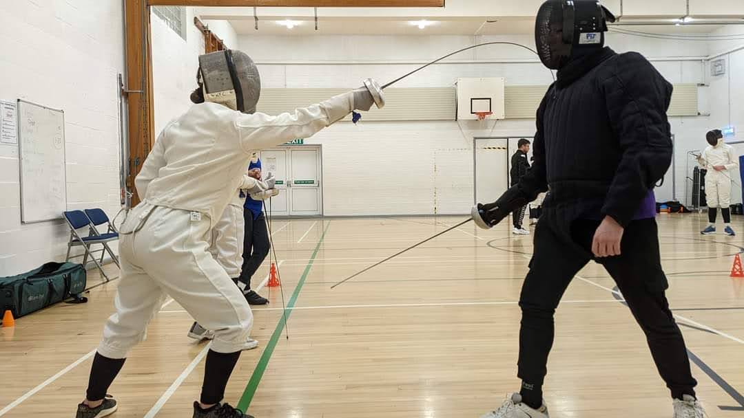 Fencers training in a sports hall